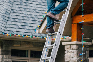 MM Handyman installing holiday lights on a Brentwood CA home safely with ladder