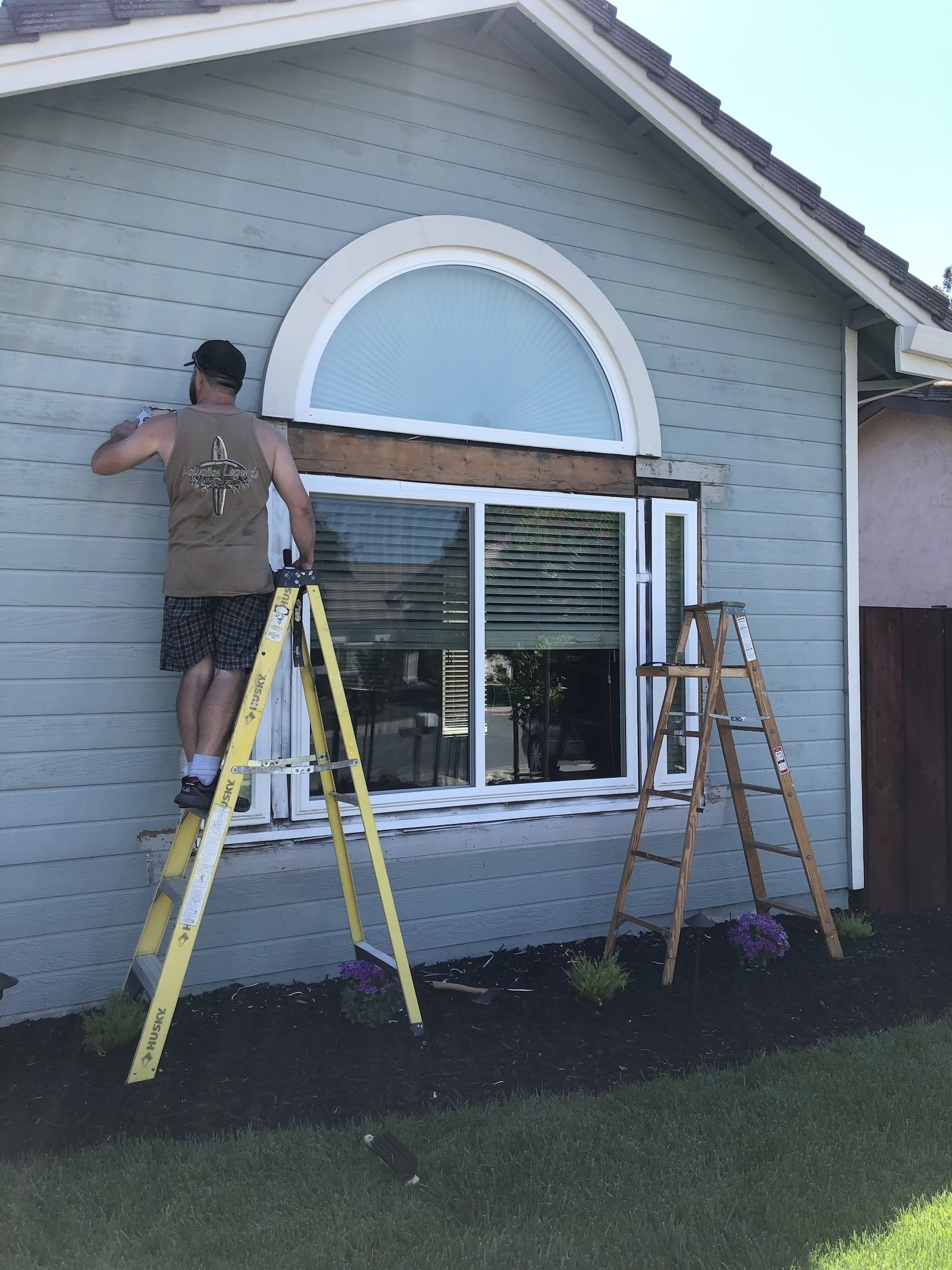 Handyman replacing exterior wood trim around a residential window in Antioch, CA